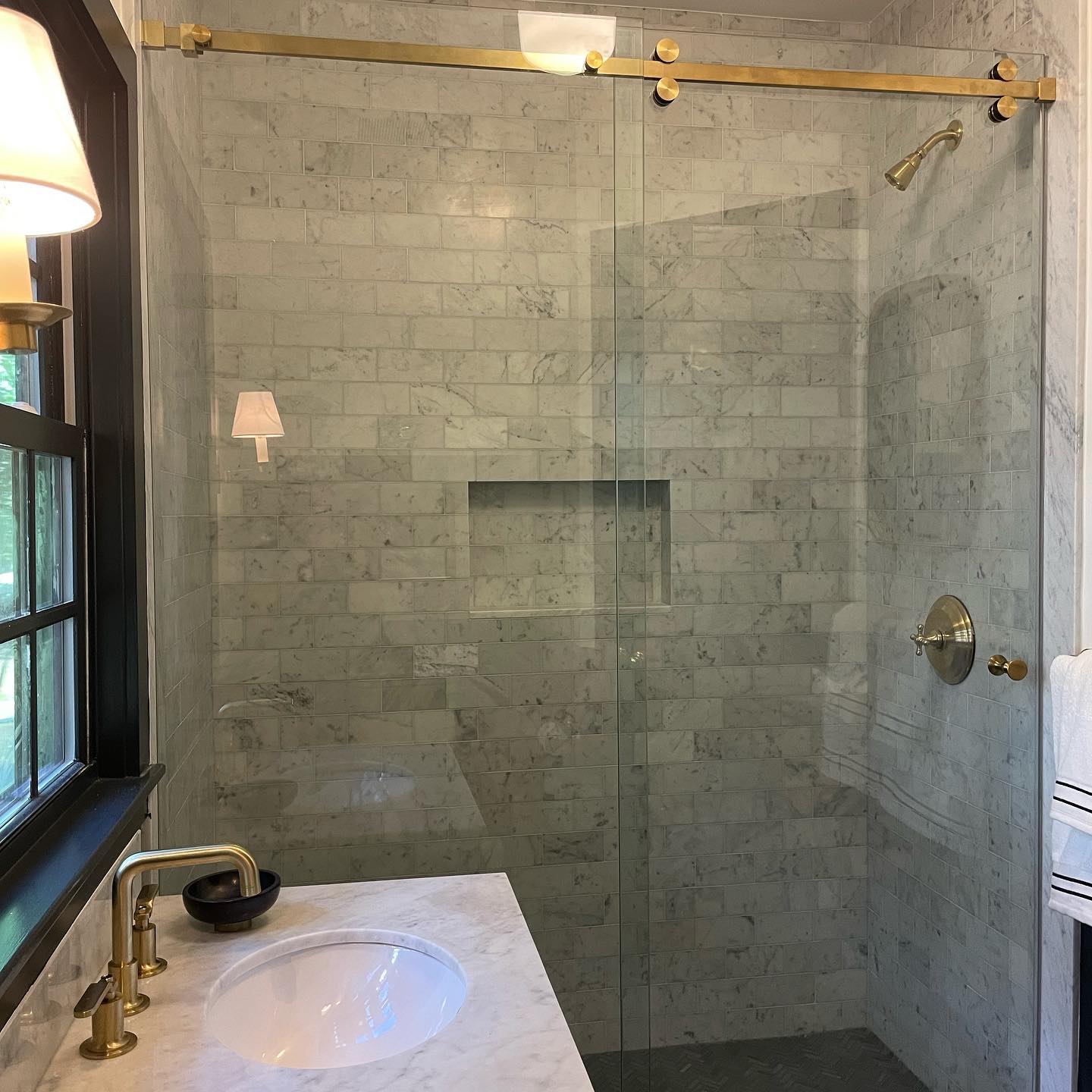 Satin brass serenity slider using 3/8” low iron glass. #barndoor #glassslider