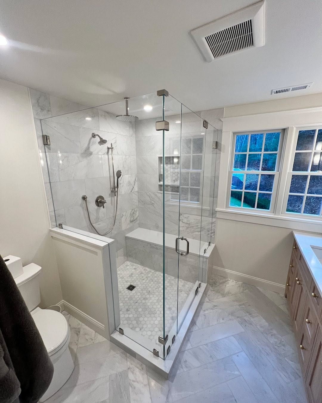 Zach installing this beautiful enclosure today. Low iron 4 panel to wrap up this bathroom project. #glassdoor #bathroomremodel #showerdoor #frameless