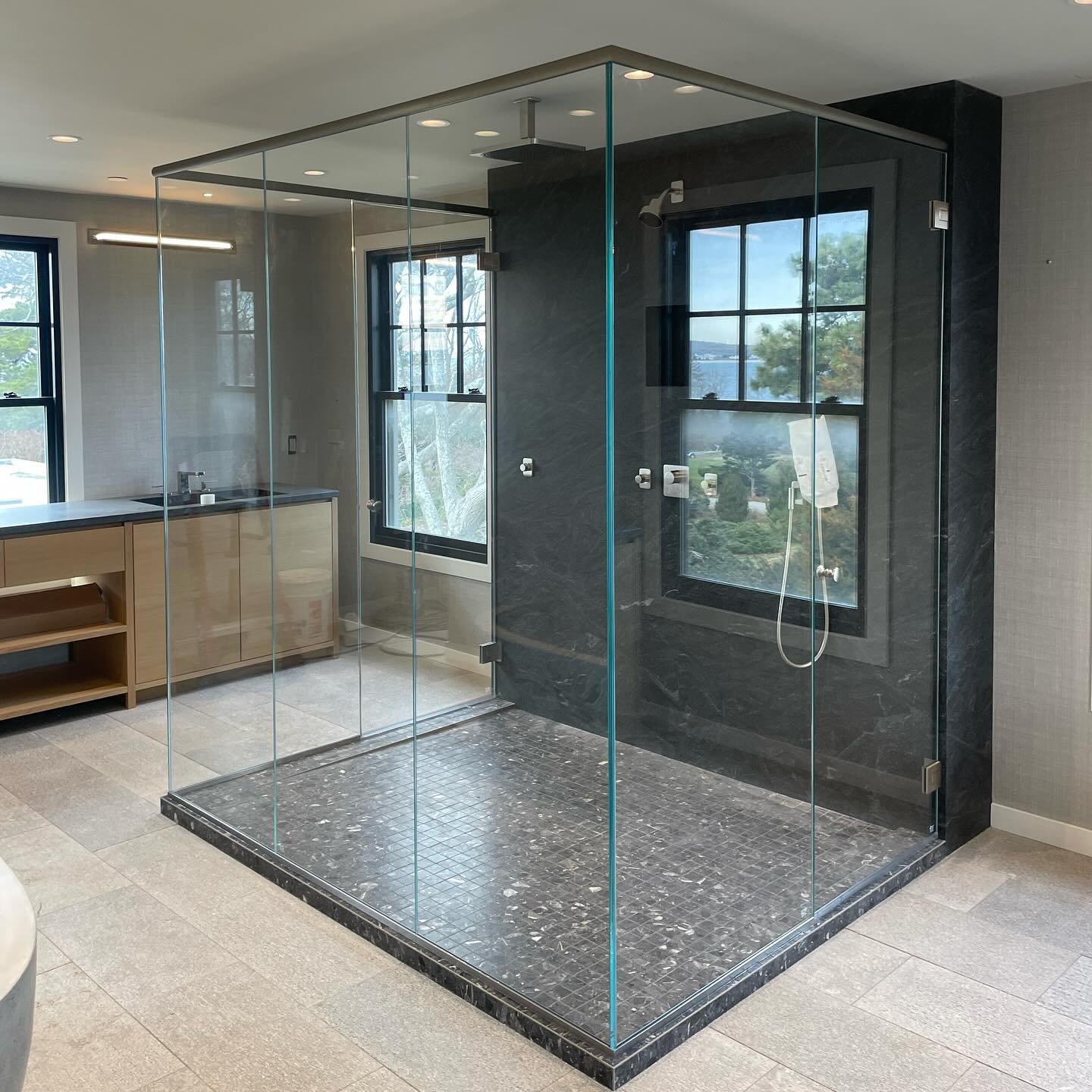 7 panel box enclosure using 1/2” low iron glass. Fun time holding the panels together until the header tied it all in. #glassshower #framelessglass #showerdoor